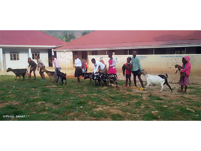 Happy students celebrating Goat Day with their goats