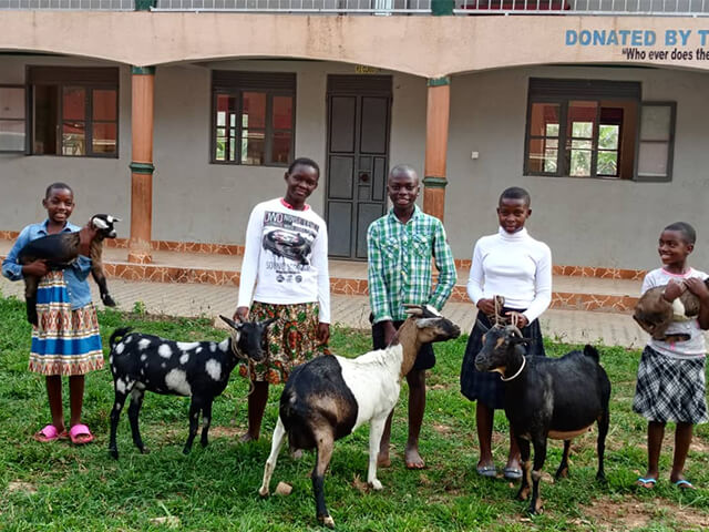 Happy students celebrating Goat Day with their goats